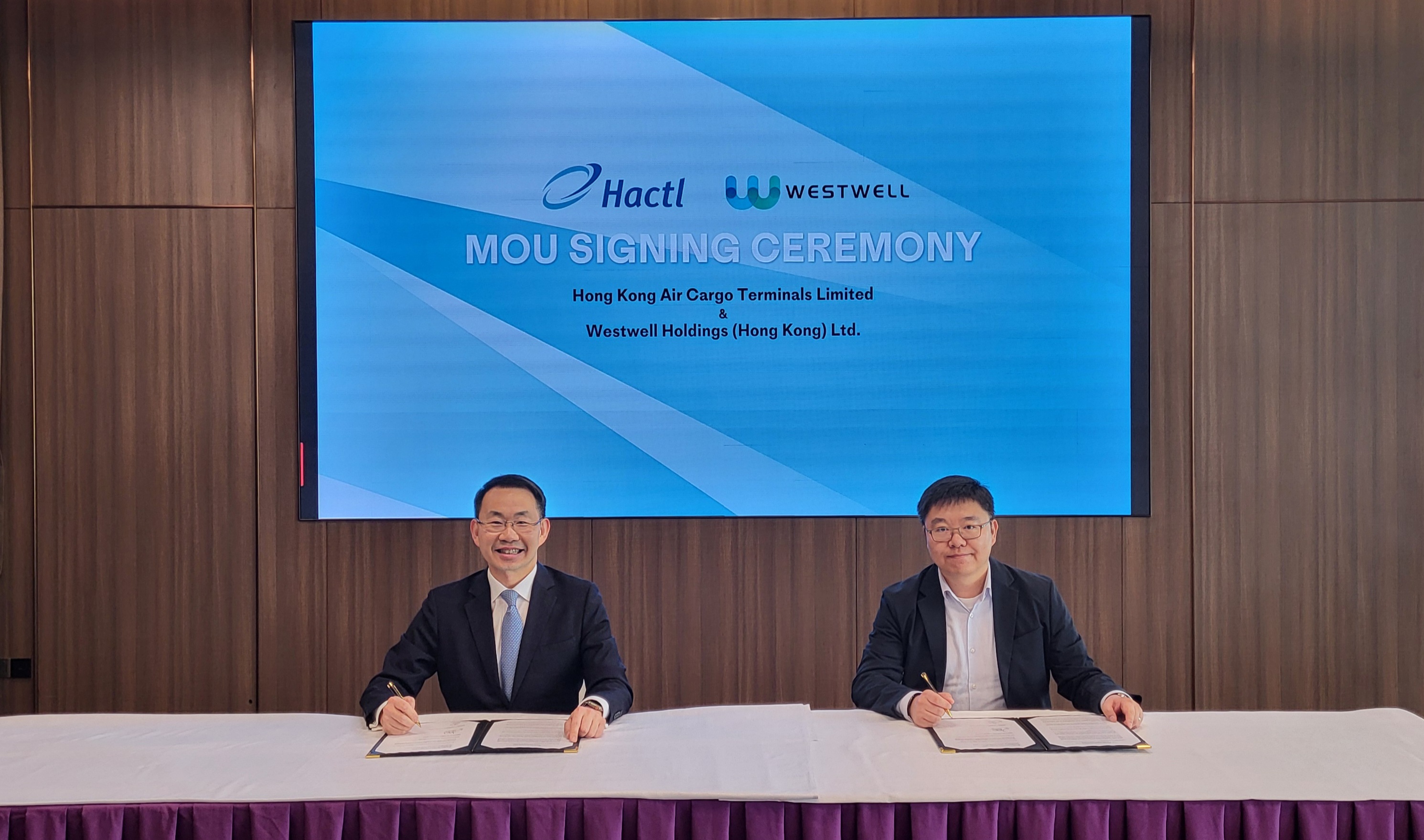 Hactl’S Chief Executive Wilson Kwong (Left) Signs The Mou With Westwell’S Chairman Kenny Tan (Right)