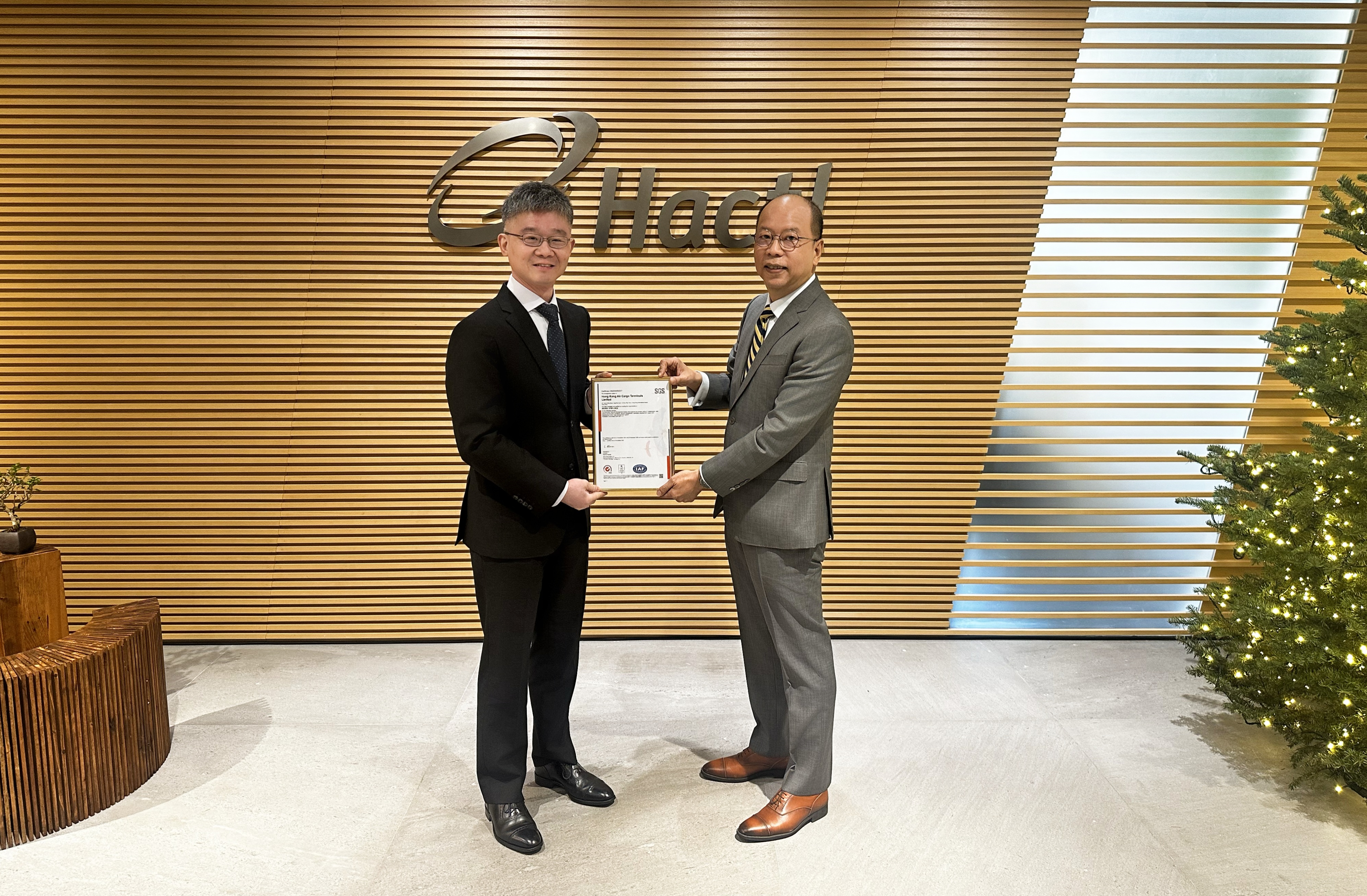 Hactl Executive Director–Information Services John Lee (Left) Received The ISO IEC 27001 2022 Certification From SGS Hong Kong Limited Deputy Director, Products & Services Development Chris Yau (Right).